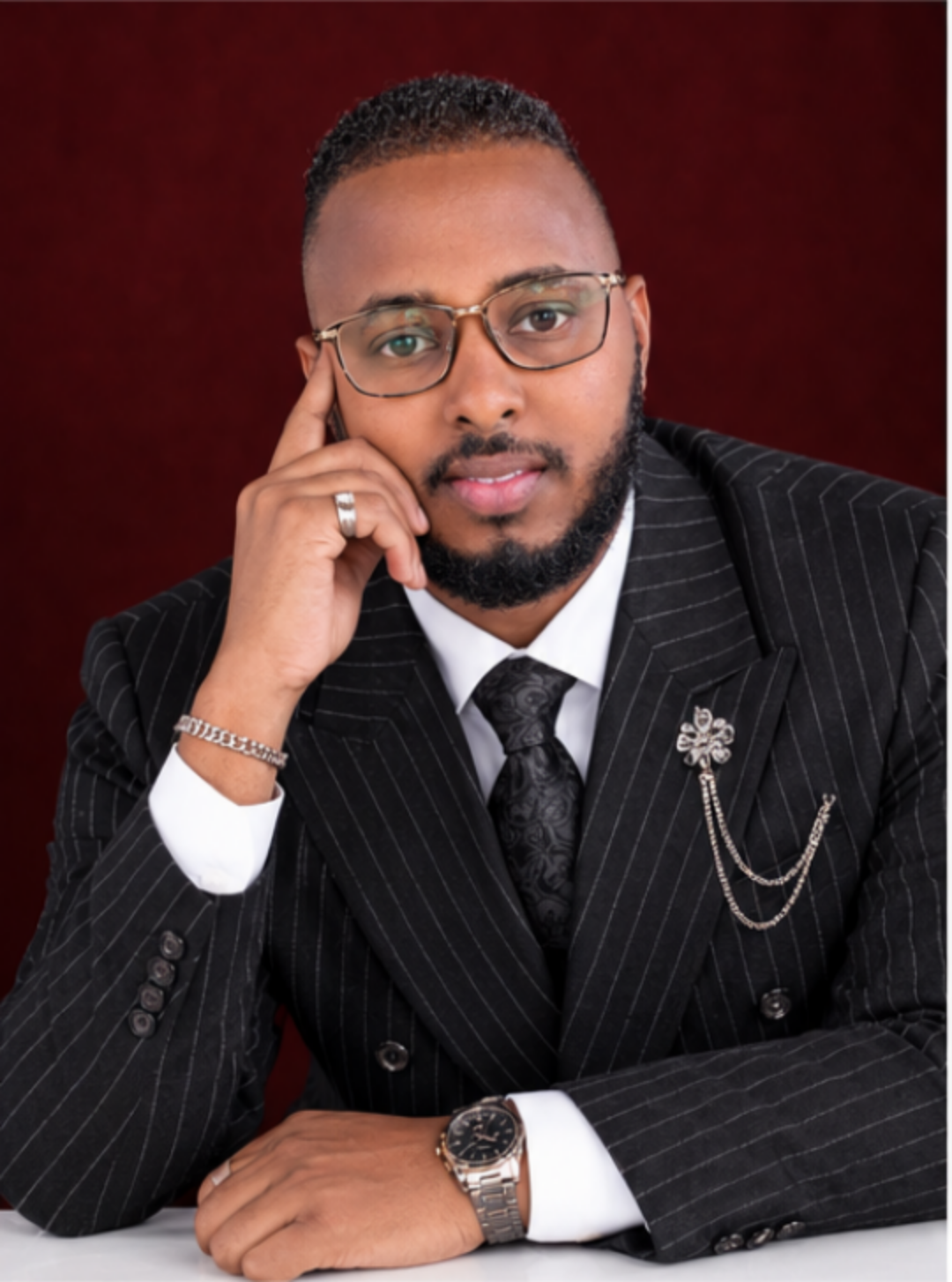 Close-up of a pinstripe suit, patterned tie and lapel accessories
